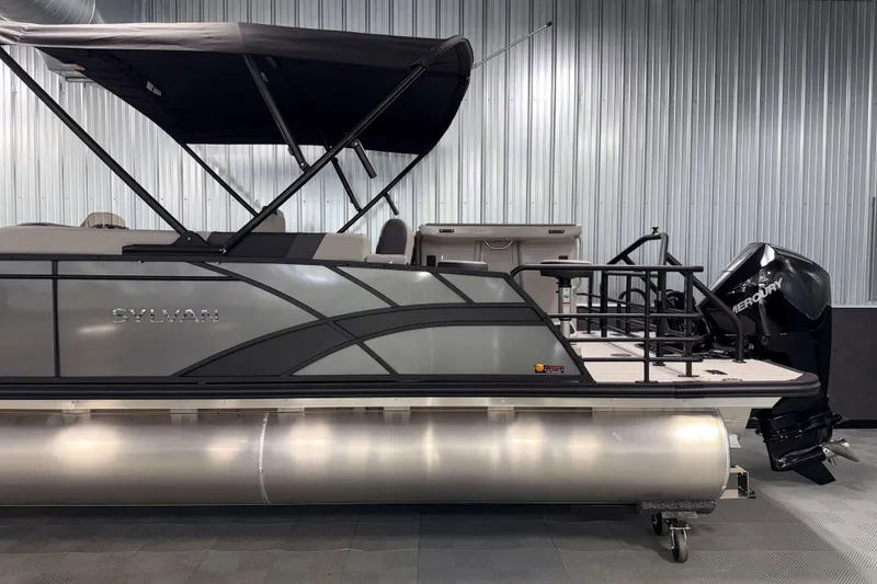 Slide: The Image of 2026 Sylvan L3 DLZ Bar pontoon boat with Mercury outboard motor in showroom. - 30