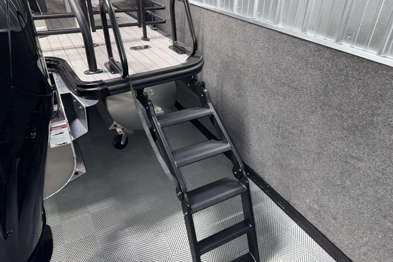 Slide: The Image of 2026 Sylvan L3 DLZ Bar boat with black ladder and sleek design. - 33