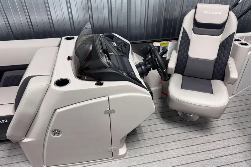 Slide: The Image of 2026 Sylvan L3 DLZ Bar boat interior with captain's chair and control console. - 9