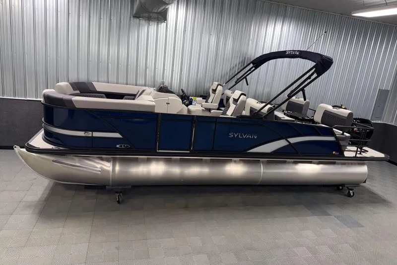The Image of 2026 Sylvan L3 RLZ pontoon boat in showroom, featuring sleek design and modern seating. - 0
