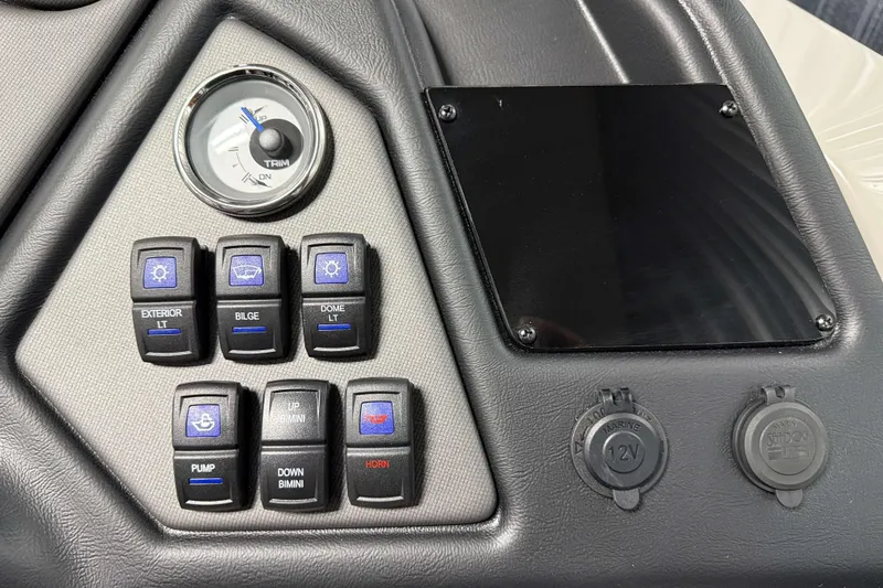 Slide: The Image of Control panel of 2026 Sylvan L3 RLZ boat with switches and trim gauge. - 15