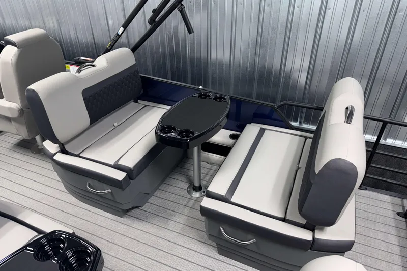 Slide: The Image of 2026 Sylvan L3 RLZ boat interior with gray seating and a central table. - 23