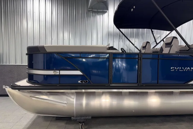 Slide: The Image of 2026 Sylvan L3 RLZ pontoon boat with blue exterior in a showroom. - 32