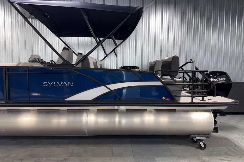 Slide: The Image of 2026 Sylvan L3 RLZ pontoon boat with blue exterior and Mercury engine. - 34