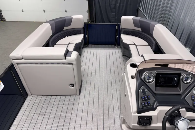 Slide: The Image of 2026 Sylvan L3 RLZ pontoon boat interior with plush seating and modern dashboard. - 6