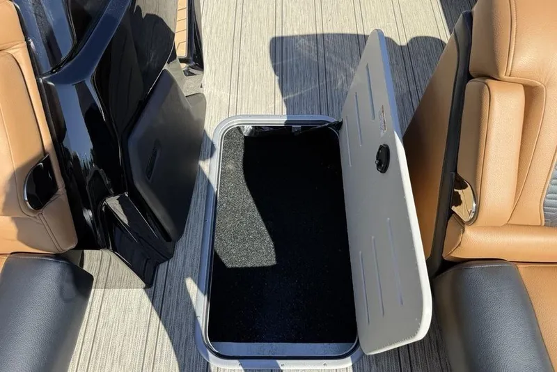 Slide: The Image of Open storage compartment on 2026 Premier 230 Intrigue RF boat with tan seating. - 14