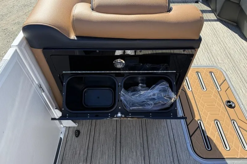 Slide: The Image of Interior view of 2026 Premier 230 Intrigue RF boat with storage compartment open. - 17