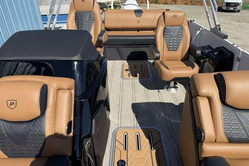 Slide: The Image of Luxurious interior of 2026 Premier 230 Intrigue RF pontoon boat with tan and black seating. - 20