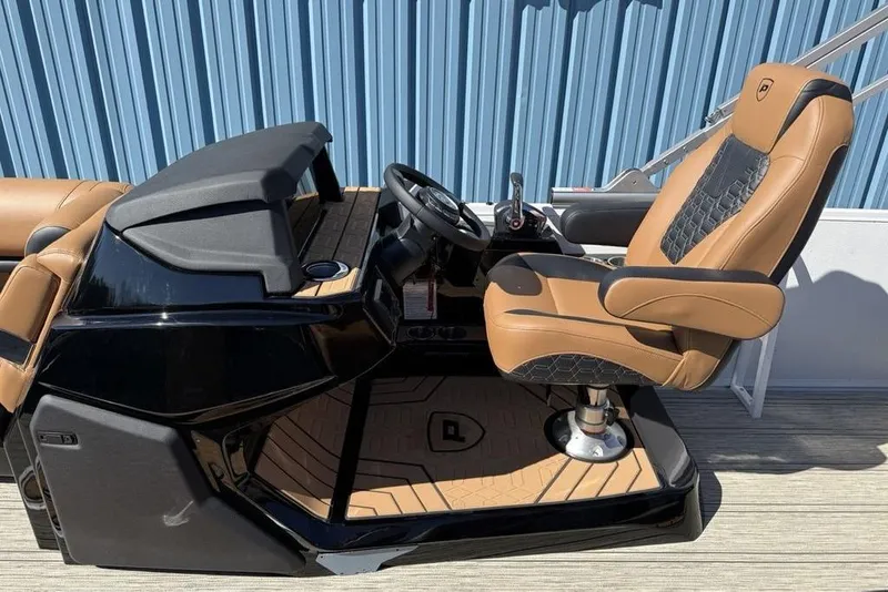Slide: The Image of Captain's chair and helm of 2026 Premier 230 Intrigue RF boat, featuring luxury design. - 22