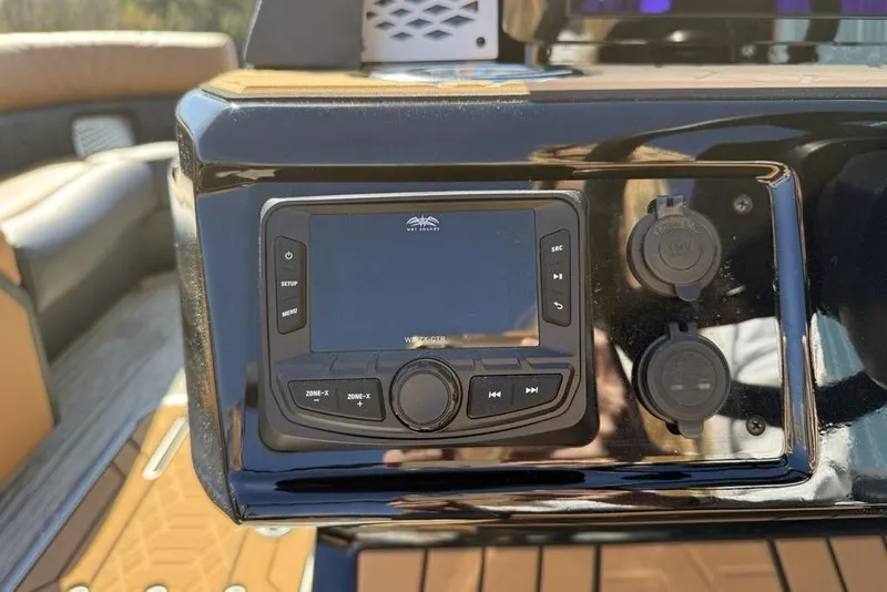 Slide: The Image of Control panel of 2026 Premier 230 Intrigue RF boat with audio system and power outlets. - 25