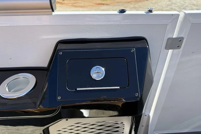 Slide: The Image of 2026 Premier 230 Intrigue RF boat detail with cup holder and storage compartment. - 27