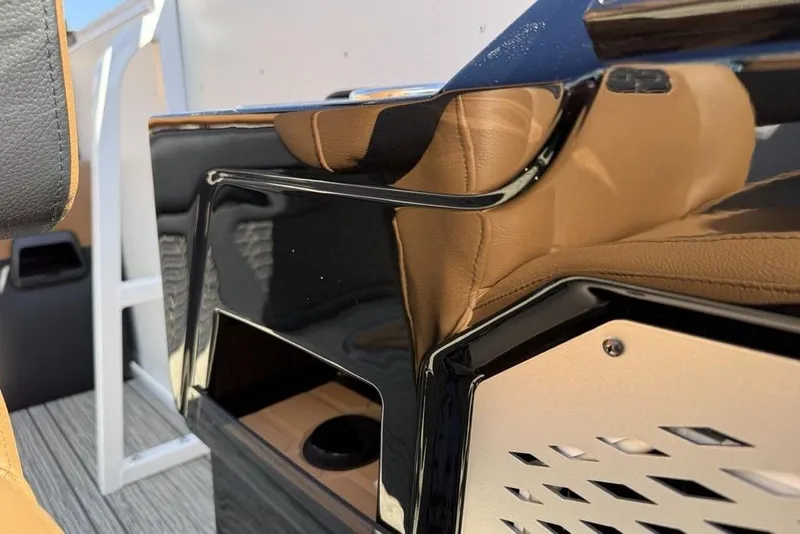 Slide: The Image of Interior detail of 2026 Premier 230 Intrigue RF boat, featuring sleek black and tan design. - 28