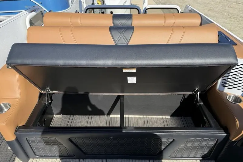 Slide: The Image of 2026 Premier 230 Intrigue RF boat seat storage compartment open, showcasing spacious interior. - 31