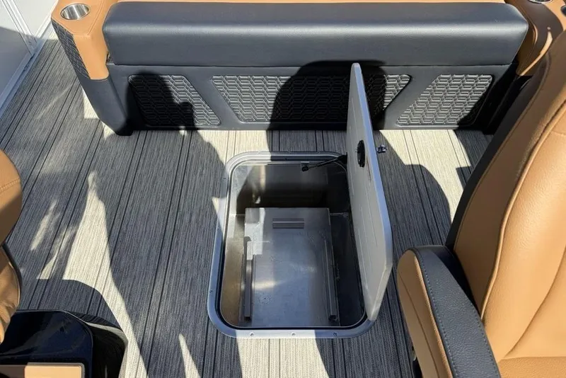 Slide: The Image of Open storage compartment on 2026 Premier 230 Intrigue RF boat with tan seating. - 33