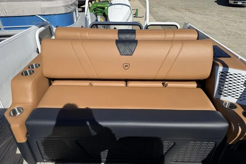 Slide: The Image of Luxurious tan seating on 2026 Premier 230 Intrigue RF boat, featuring cup holders and stylish design. - 34