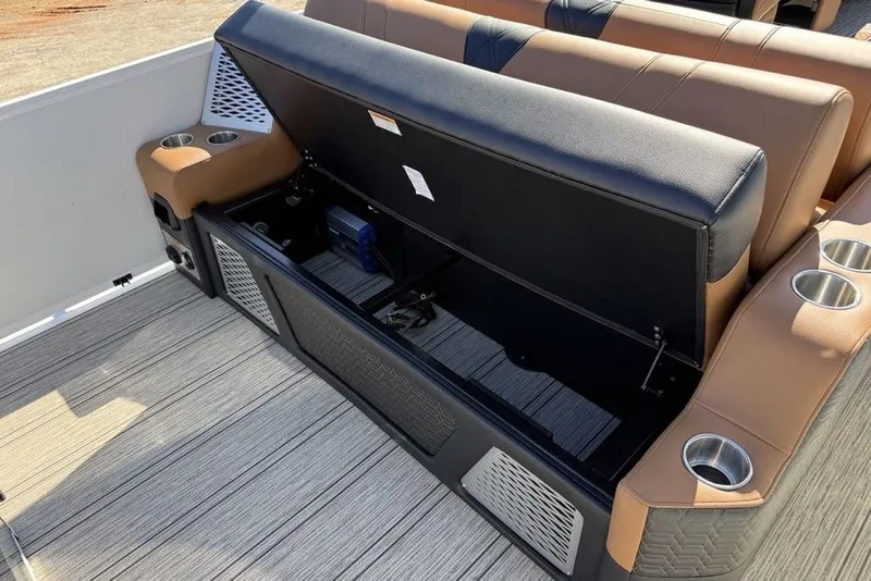Slide: The Image of Open storage compartment on 2026 Premier 230 Intrigue RF boat with cup holders. - 38