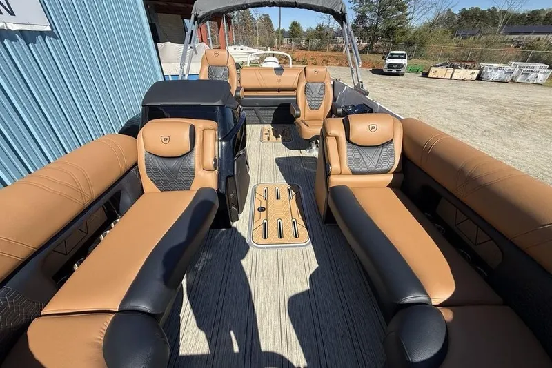 Slide: The Image of Luxurious interior of 2026 Premier 230 Intrigue RF pontoon boat with tan and black seating. - 45