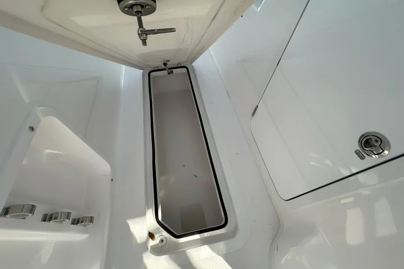 Slide: The Image of 2026 Twin Vee 340 GFX2 CC boat interior storage compartment with sleek white finish. - 12