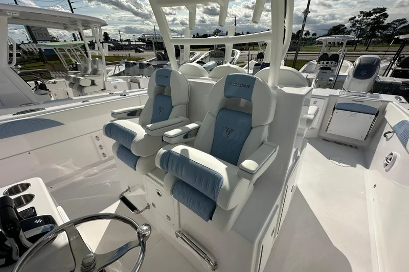 Slide: The Image of 2026 Twin Vee 340 GFX2 CC boat interior with luxurious seating and steering wheel. - 13