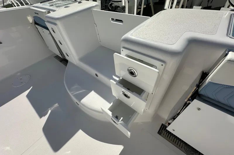 Slide: The Image of 2026 Twin Vee 340 GFX2 CC boat interior with open storage compartments. - 18