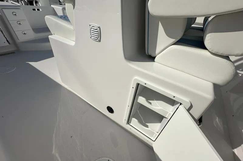 Slide: The Image of 2026 Twin Vee 340 GFX2 CC boat interior with open storage compartment and seating. - 21