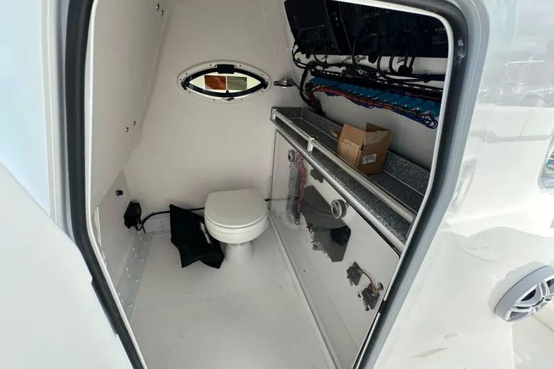 Slide: The Image of Interior of 2026 Twin Vee 340 GFX2 CC boat with toilet and storage. - 11