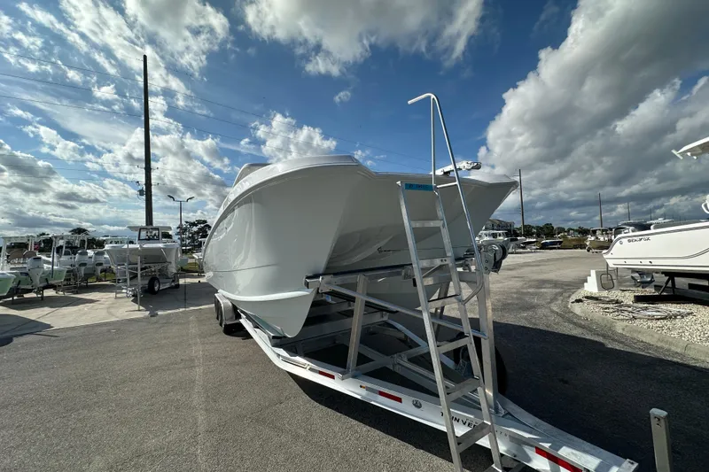 Slide: The Image of 2026 Twin Vee 340 GFX2 CC boat on trailer under cloudy sky. - 2