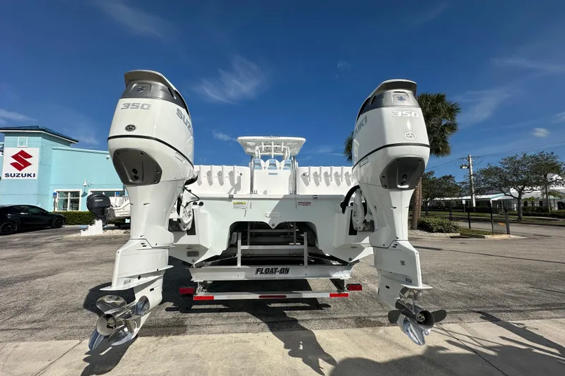 Slide: The Image of 2026 Twin Vee 340 GFX2 CC boat with dual Suzuki 350 engines on a trailer. - 5