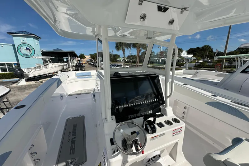 Slide: The Image of 2026 Twin Vee 340 GFX2 CC boat interior with modern console and steering wheel. - 6