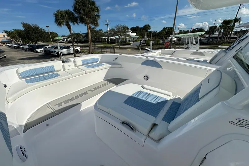 Slide: The Image of 2026 Twin Vee 340 GFX2 CC boat interior with blue and white seating, outdoor setting. - 8