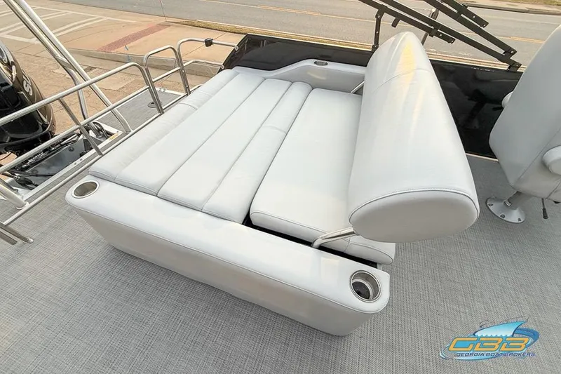 Slide: The Image of 2022 Bentley 243 Swingback boat with luxurious white seating and cup holders. - 13