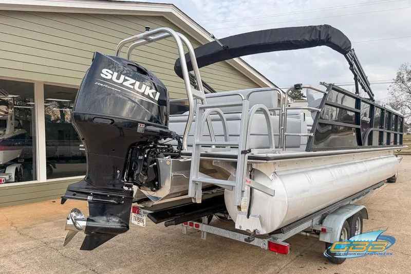 Slide: The Image of 2022 Bentley 243 Swingback pontoon boat with Suzuki outboard motor on trailer. - 18