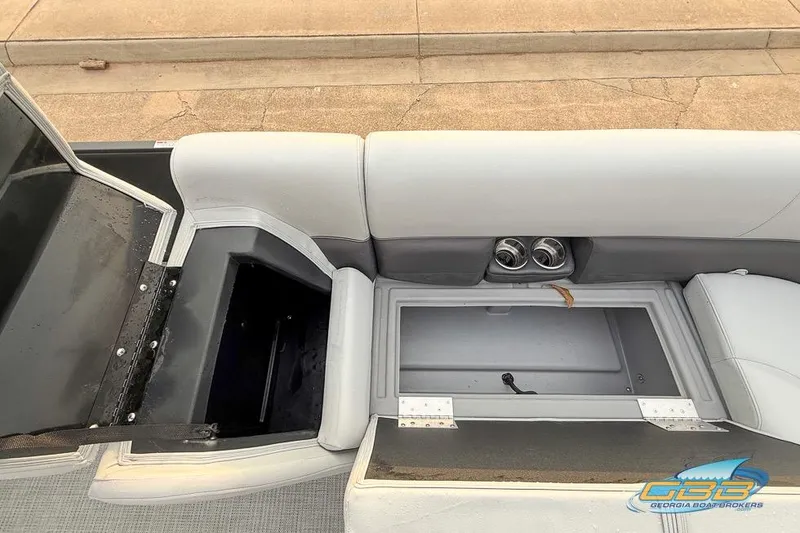 Slide: The Image of 2022 Bentley 243 Swingback boat interior with open storage compartments and cup holders. - 19