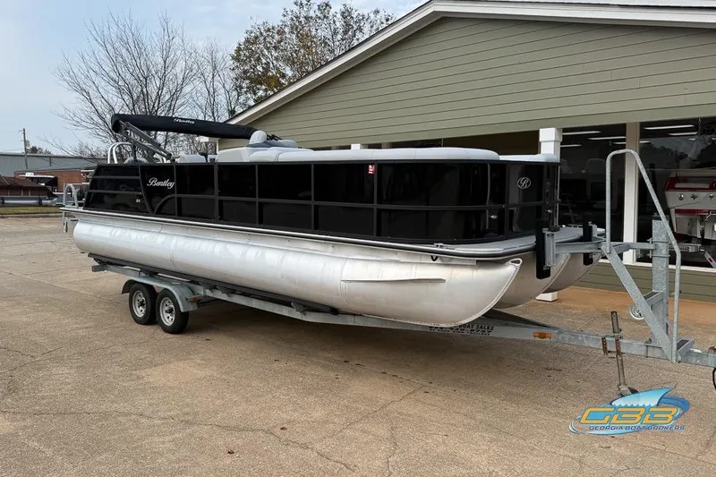 Slide: The Image of 2022 Bentley 243 Swingback pontoon boat on trailer outside dealership. - 9