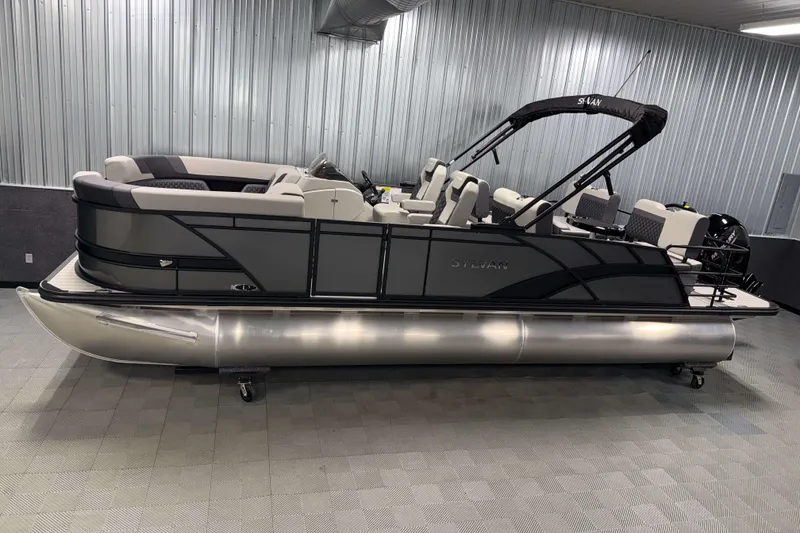 The Image of 2026 Sylvan L3 RLZ pontoon boat in a showroom with sleek design and modern seating. - 0