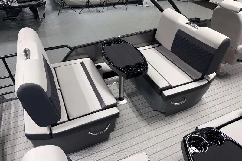 Slide: The Image of 2026 Sylvan L3 RLZ boat interior with gray seating and black table. - 17