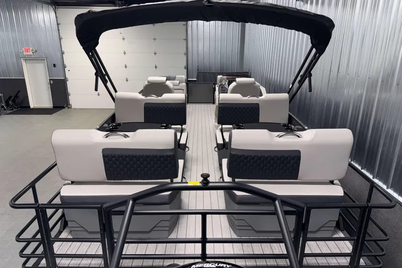 Slide: The Image of 2026 Sylvan L3 RLZ pontoon boat interior with modern seating and canopy in a showroom. - 25