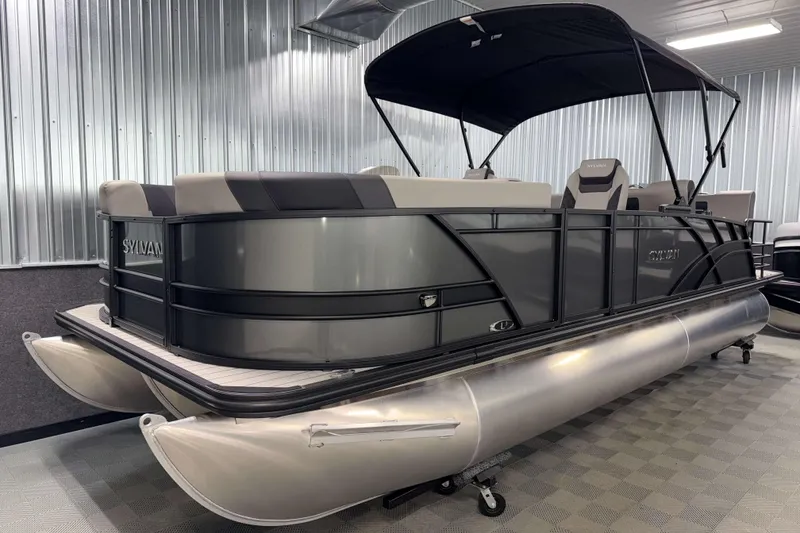 Slide: The Image of 2026 Sylvan L3 RLZ pontoon boat in showroom, featuring sleek design and canopy. - 26