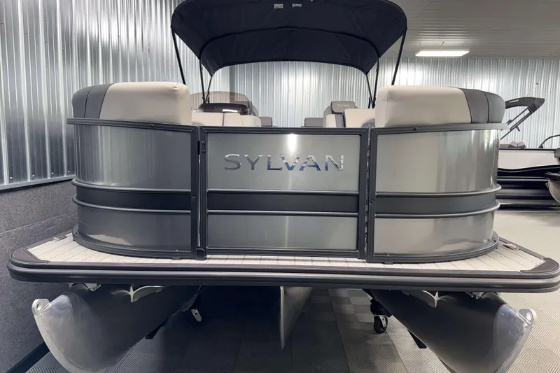 Slide: The Image of 2026 Sylvan L3 RLZ pontoon boat in showroom, featuring sleek design and comfortable seating. - 27