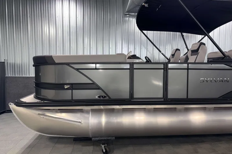 Slide: The Image of 2026 Sylvan L3 RLZ pontoon boat with sleek design in a showroom setting. - 29