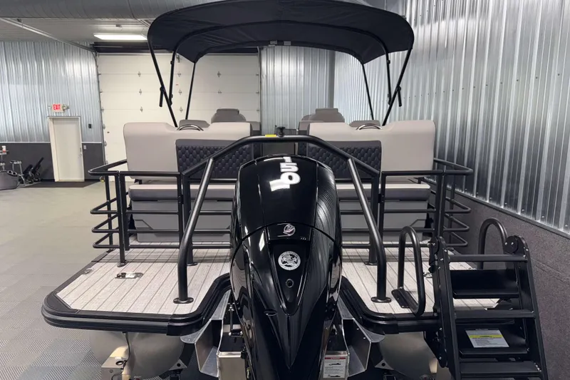 Slide: The Image of 2026 Sylvan L3 RLZ pontoon boat with outboard motor in a showroom. - 33