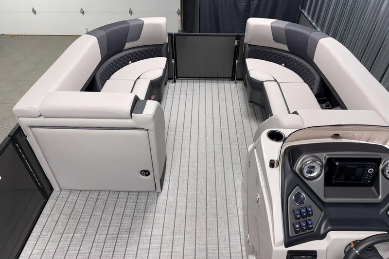 Slide: The Image of 2026 Sylvan L3 RLZ pontoon boat interior with plush seating and modern dashboard. - 6