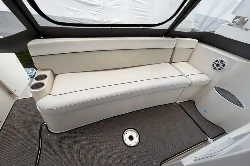 Slide: The Image of 2007 Rinker 370 Express Cruiser Hard Top interior with white seating and cup holders. - 11