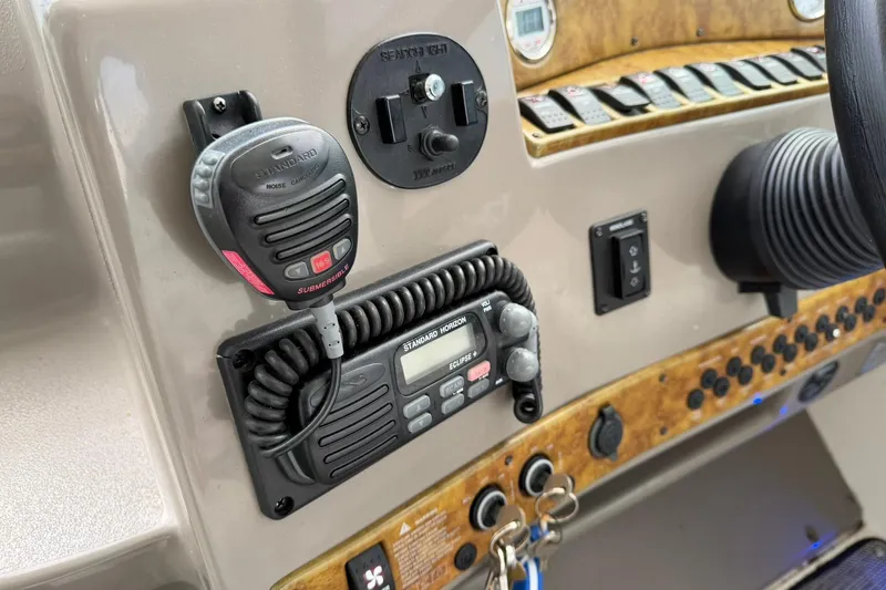 Slide: The Image of Control panel of a 2007 Rinker 370 Express Cruiser Hard Top with radio and switches. - 14