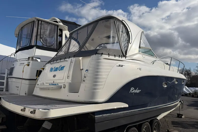 Slide: The Image of 2007 Rinker 370 Express Cruiser Hard Top docked under cloudy sky. - 2
