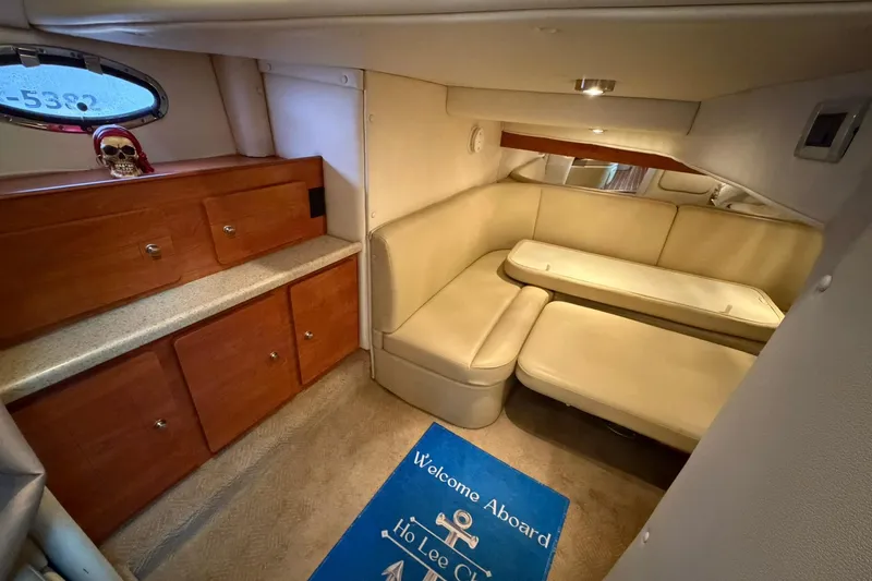 Slide: The Image of 2007 Rinker 370 Express Cruiser interior with beige seating and wooden cabinetry. - 26