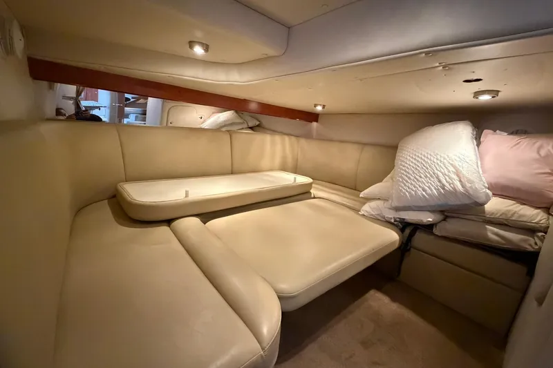 Slide: The Image of 2007 Rinker 370 Express Cruiser Hard Top interior with beige seating and cushions. - 27