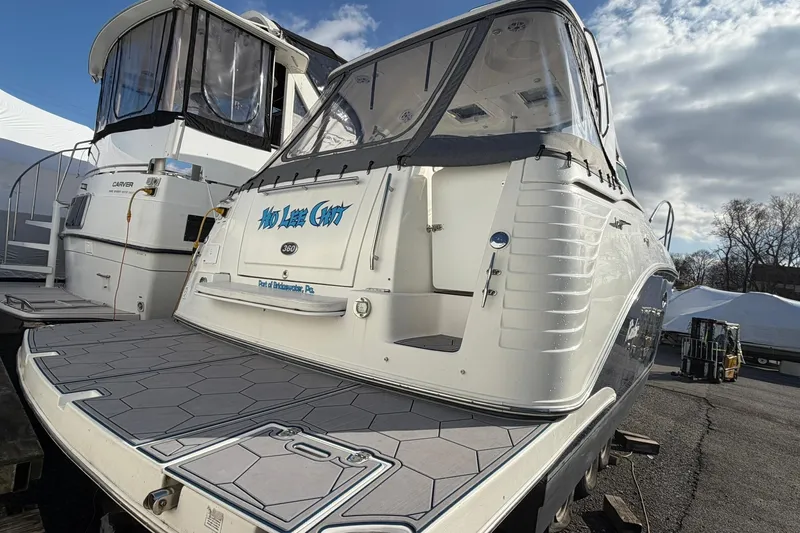 Slide: The Image of 2007 Rinker 370 Express Cruiser Hard Top docked, featuring spacious deck and sleek design. - 3