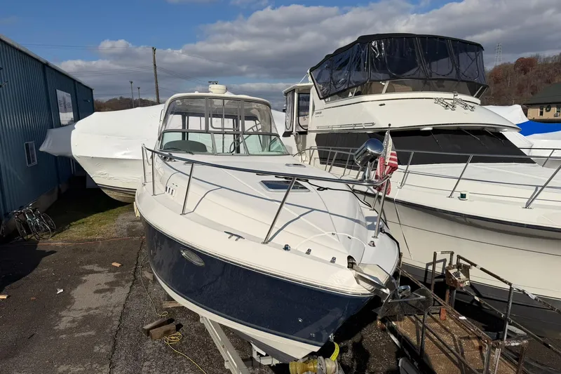 Slide: The Image of 2007 Rinker 370 Express Cruiser Hard Top docked beside other boats. - 7
