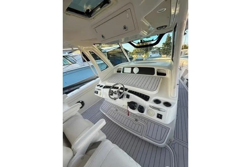 Slide: The Image of 2020 Grady-White Canyon 376 boat with triple outboard engines in a marina setting. - 11